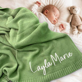 Sage green personalised name blanket on a sleeping baby with teddy bear
